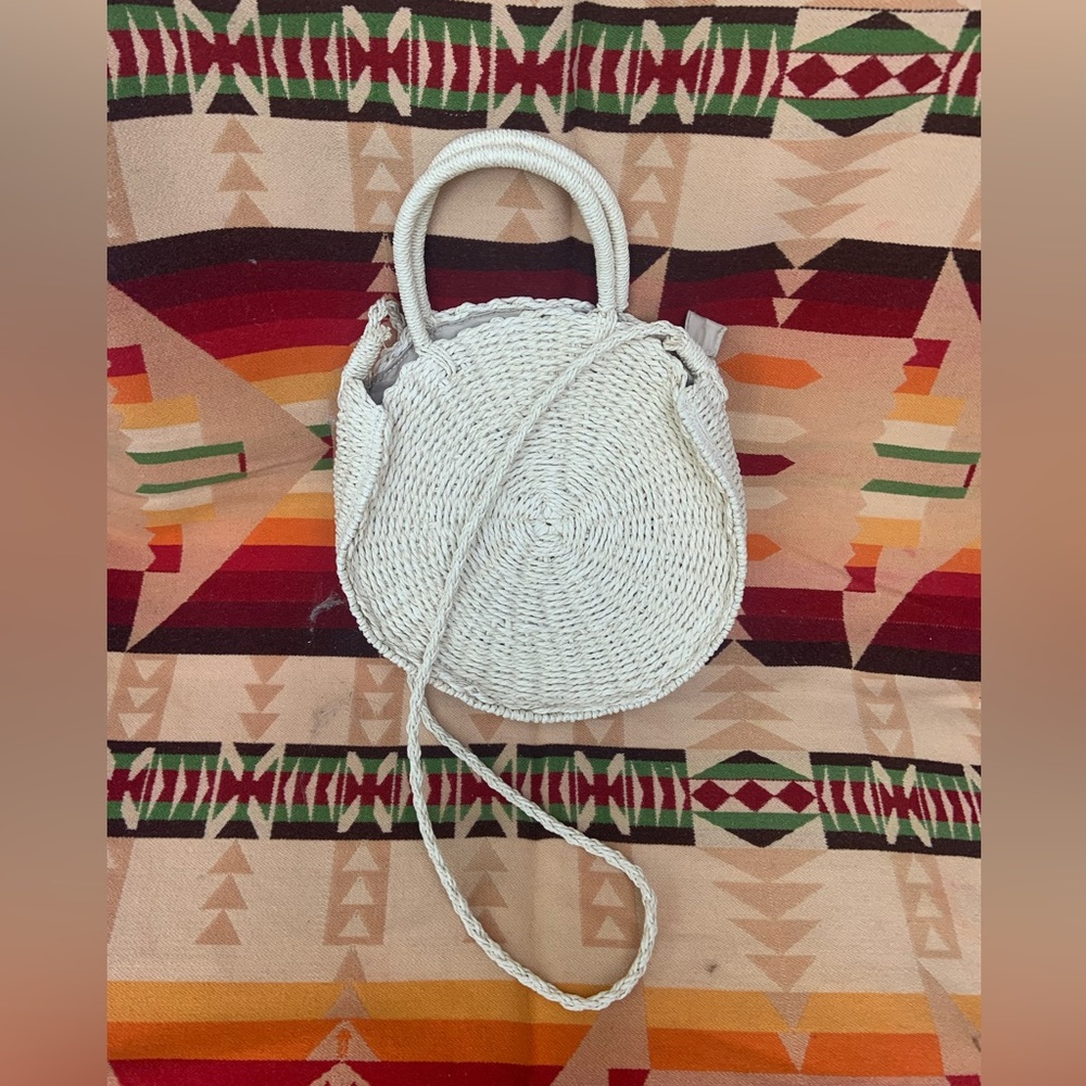 Woven straw lined purse. Crossbody and handles.